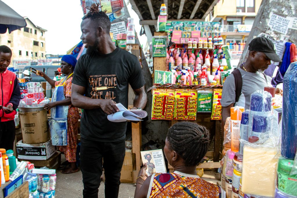 A volunteer interacting with market wome